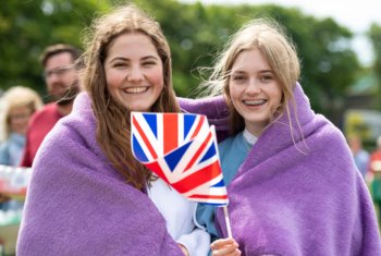  Pupils with Great Britain  flags enjoying celebrations for the Platinum Jubilee 