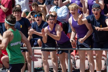  School House pupils cheering on their house in a Sports Day track event 