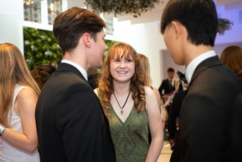  L6th pupils in black tie enjoying talking at the UNICEF Ball 