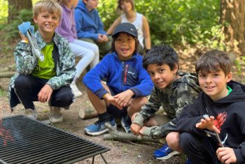  Year 4 Prep School pupils enjoying cooking on a residential school trip 