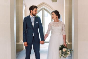  Newlyweds holding hands and smiling after their wedding ceremony 