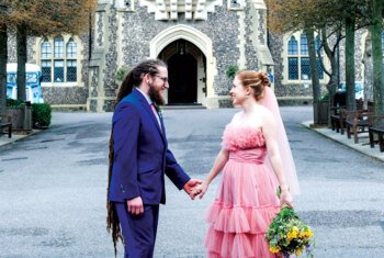  Bride and Groom holding hands in the Quad after their wedding ceremony 