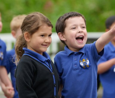  Nursery pupils in uniform having fun playing together 