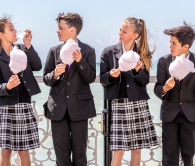  Pupils enjoying eating candy floss on Brighton Pier 