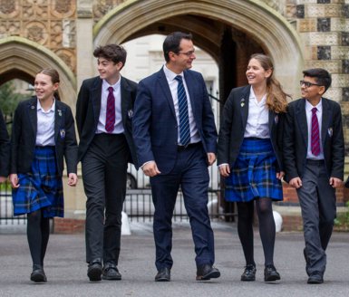  Prep-School pupils in uniform and Prep-School Headmaster Ant Falkus walking through the Quad 