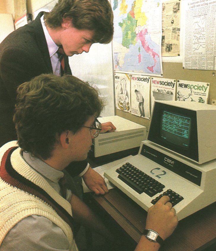  Archive photograph of pupils working together on an old computer 