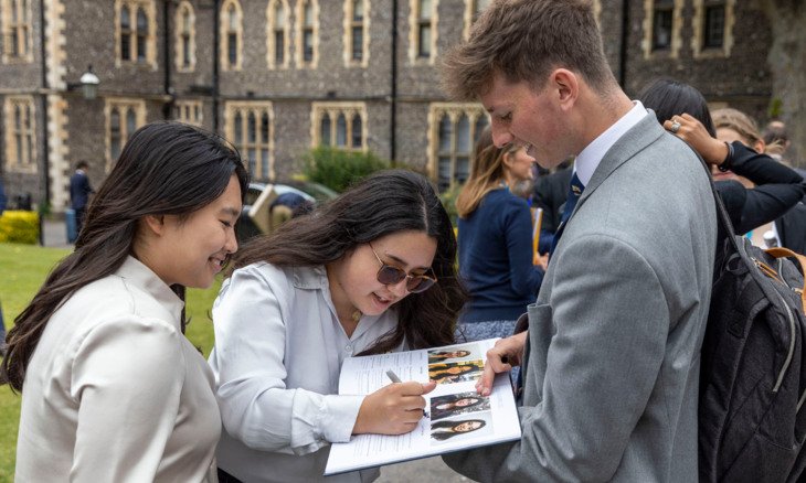  Pupils in the Quad signing each others year books at Graduation 