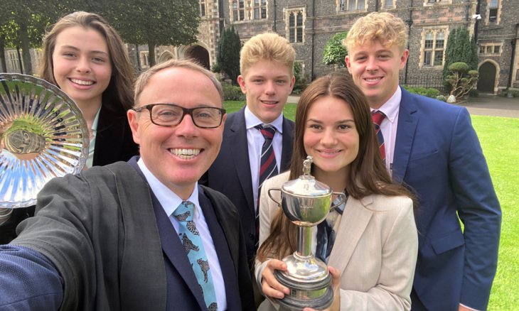  Sixth Form pupils with Richard Cairns and the Headmaster of the Year trophy 