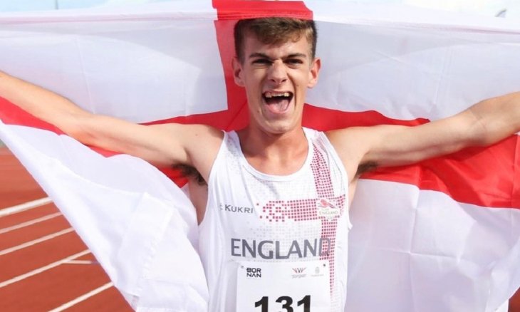  Miles Waterworth holding the English flag around him at the Youth Commonwealth Games 