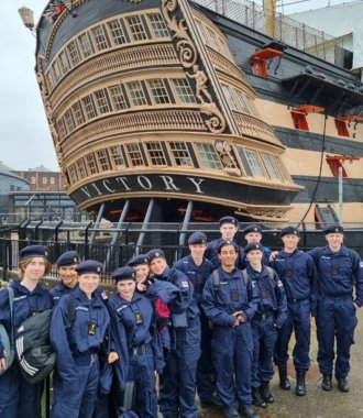  Lower Fifth pupils in the Navy standing in front of the HMS Victory on a CCF trip to Portsmouth 