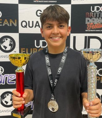  Forrest holding his trophies and with a medal at the UDO Southern Streetdance Championships 