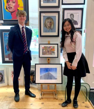  Kelly and Matthew proudly showing their art and photography pieces to be displayed in a local gallery 