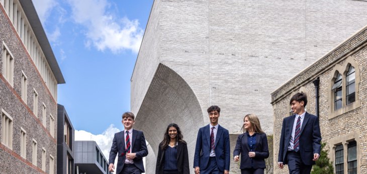  Sixth Form pupils talking as they walk past the Richard Cairns Building 