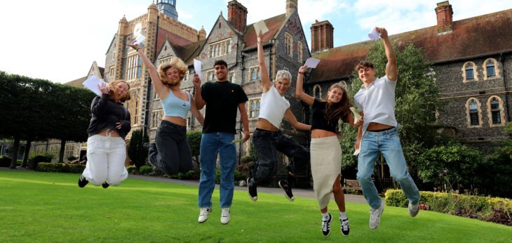  Pupils in the Quad jumping for joy on A-Level Results Day holding their results 