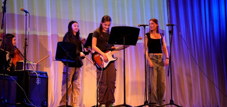  Pupils singing and playing the electric guitar on stage for Boarders Got Talent 