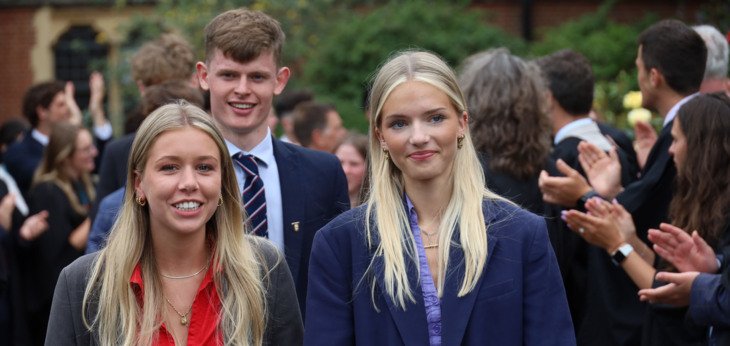  Pupils being clapped as they walk out of Chapel after their Graduation 