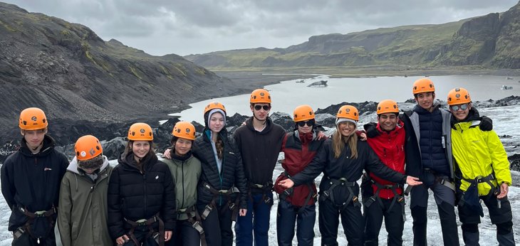  Pupils in climbing harnesses and helmets enjoying exploring on their Geography Trip to Iceland 