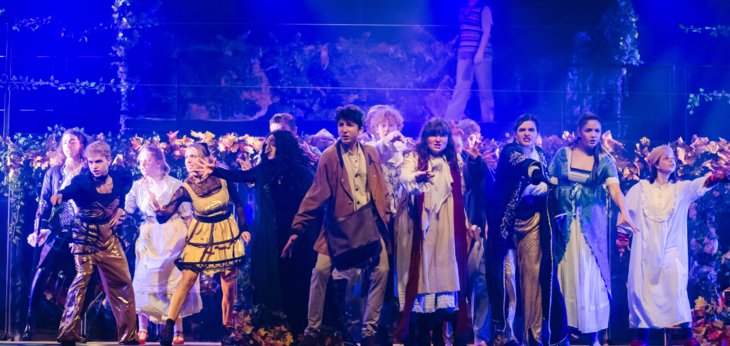  Cast in costume on stage performing in the production of Into the Woods 