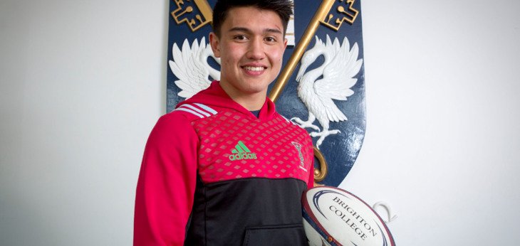  Marcus Smith International Rugby player holding a Brighton College rugby ball in Harlequins kit 