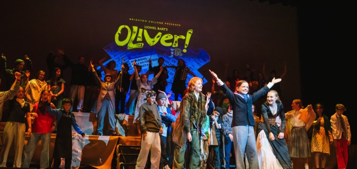  Cast of Oliver onstage applauding the pupil playing Oliver in the final bows 