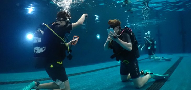  Pupils in the pool with scuba equipment conducting experiments in Scuba Physics 