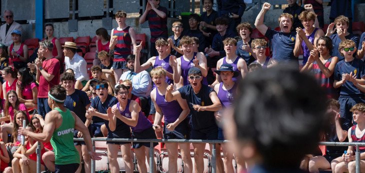  Pupils in the stands cheering on fellow members of their house as they compete on the track at Sports Day 