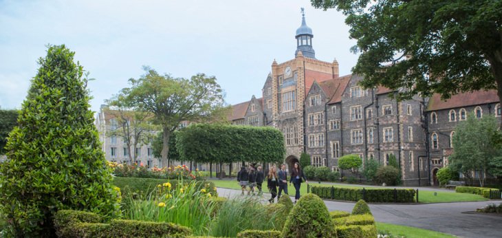  A view across the Quad of the Cairns Tower and pupils walking along the path 