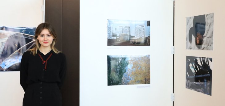  Ukrainian pupil Liia next to artwork displayed at the 2nd Anniversary Exhibition for Ukraine 