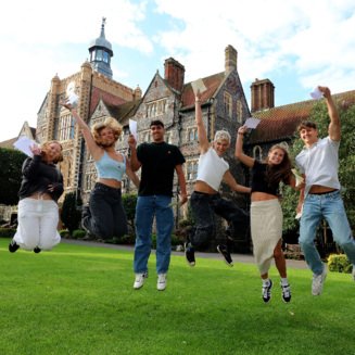 Pupils in the Quad jumping for joy on A-Level Results Day holding their results