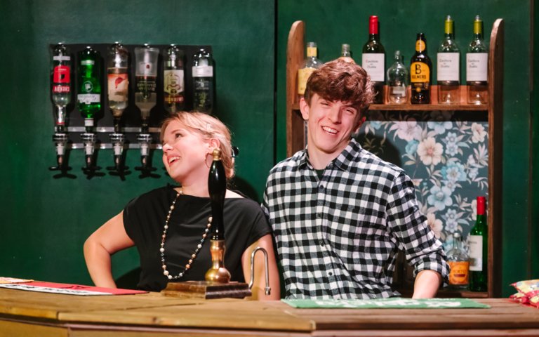  Lower Sixth pupils behind a bar performing in their production of Two 