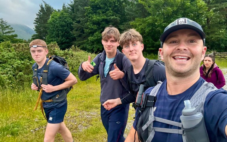  Pupils and staff taking a selfie as they are walking on their Three Peaks Challenge to raise money for charity 