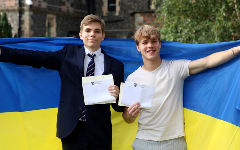  Ukrainian pupils holding their results and the Ukrainian flag on A-Level Results Day 