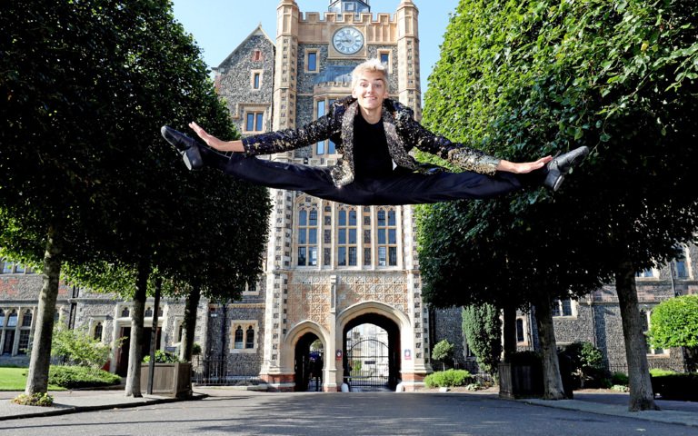  Dancer in a high split jump in front of the Cairns Tower celebrating on A-Level Results Day 