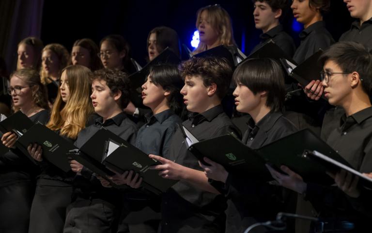  Chamber Choir on stage holding their music performing in the Film Concert 