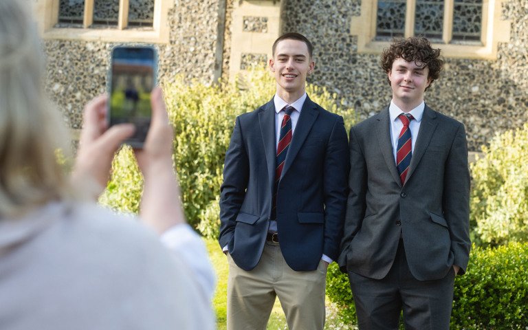  Pupils posing for a photograph outside the Chapel after the Graduation 