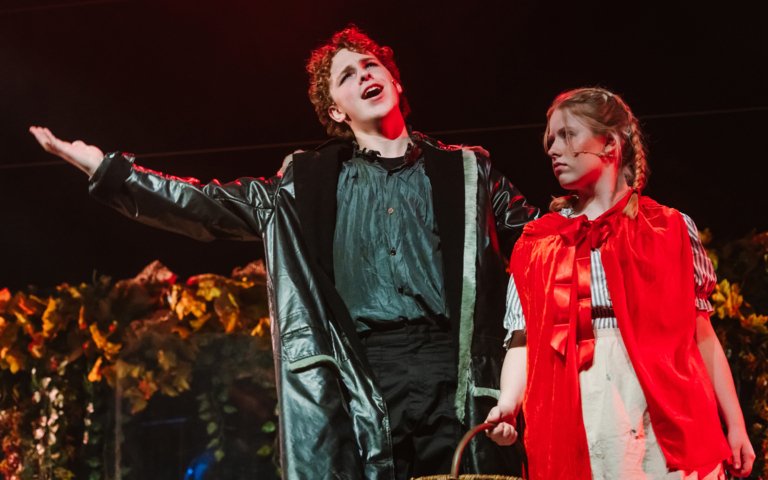  Pupils acting as Little Red Riding Hood and the Wolf in Into the Woods on stage 