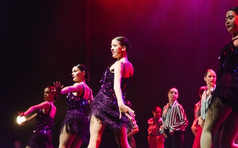  Dancers in 1920s inspired dresses performing a piece on stage in the Dance Show 