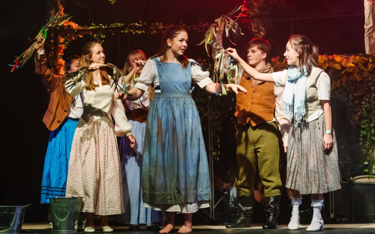  Pupils in costume on stage performing as Cinderella in the production of Into the Woods 