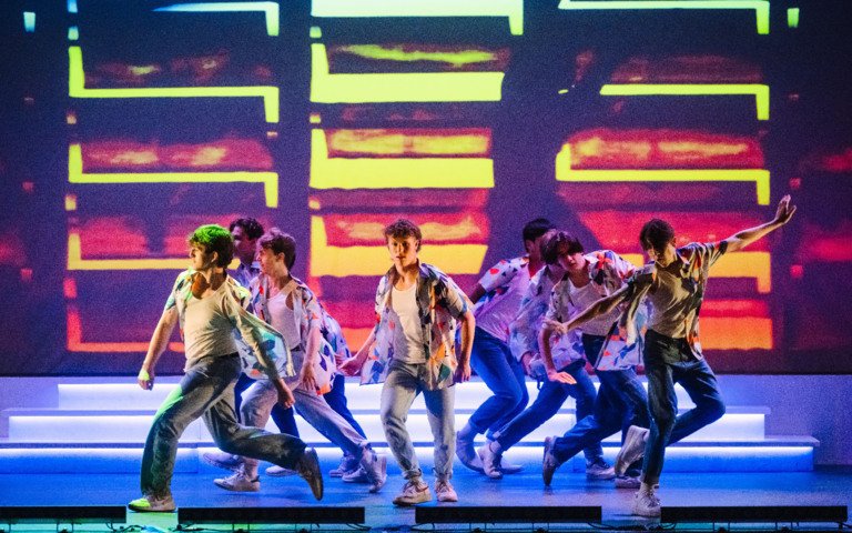  Dancers performing a group piece on stage at the Dance Show 