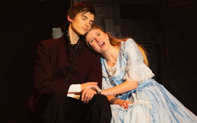  Pupils on stage playing Cosette and Marius in a production of Les Misérables 