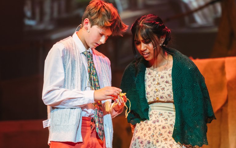  Pupils performing a scene in the Lower School production of Oliver 