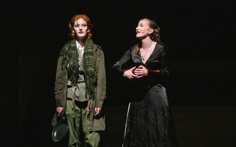  Pupils on stage performing a scene from the musical Oliver 