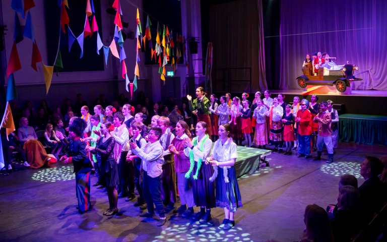  Prep School pupils on stage in the Great Hall performing the final bows in their production of Chitty Chitty Bang Bang 