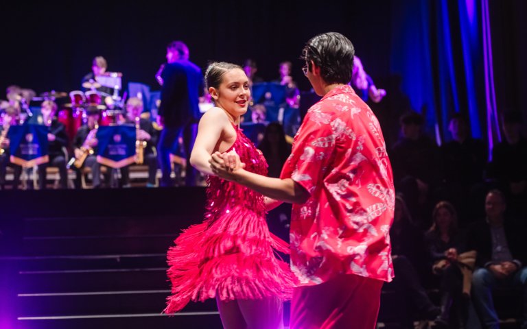  Pupils in pink outfits dancing in the finals of the Strictly Come Dancing competition on stage 