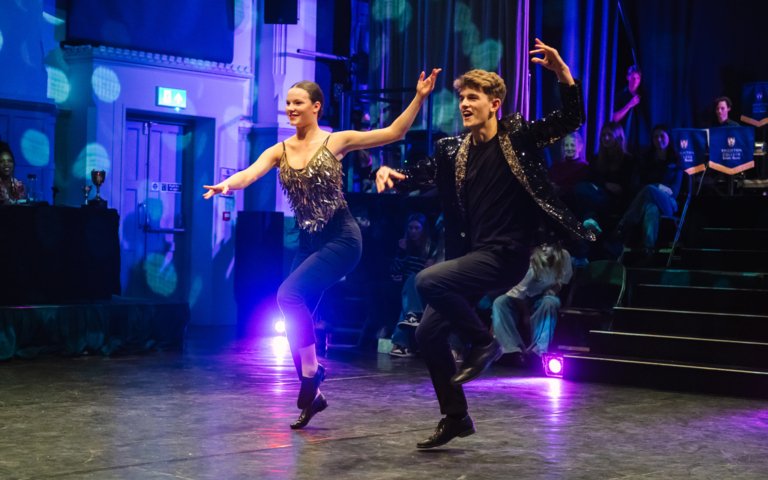  Pupils on stage dancing a duet in the Strictly competition 