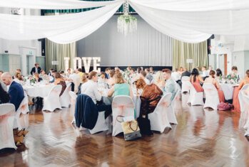 Wedding guests sat at their tables enjoying the wedding reception