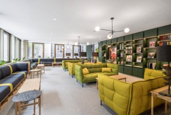 Socialising area in the Sixth Form Club with sofas and bookshelves