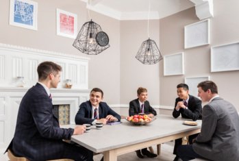 Boarders with cups of tea enjoying chatting in their break time in the Common Room