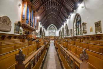 View down the aisle of the benches in the College Chapel