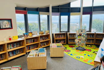 Books on display and a reading carpet in the Pre-Prep Library